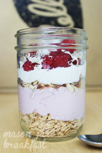 finished yogurt parfait in a Mason jar with raspberries and white chocolate
